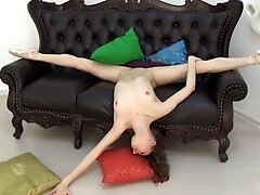 'Flexible Ballerina Posing on the Black Leather Sofa'